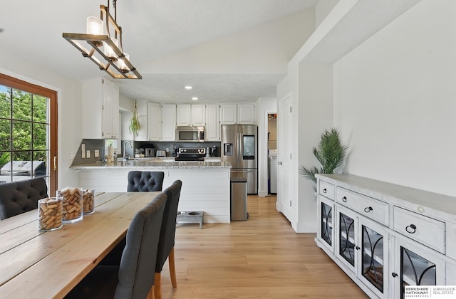 4019 N 147th St, Omaha, NE 68116 - dining area with vaulted ceiling, light wood-style flooring, recessed lighting, and a chandelier
