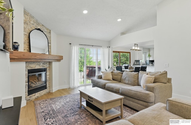 4019 N 147th St, Omaha, NE 68116 - living area featuring a fireplace, lofted ceiling, wood finished floors, recessed lighting, and a chandelier