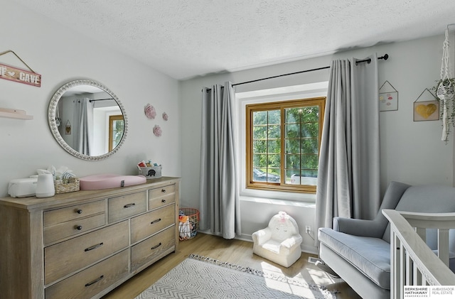 4019 N 147th St, Omaha, NE 68116 - bedroom with light wood-style floors and a textured ceiling