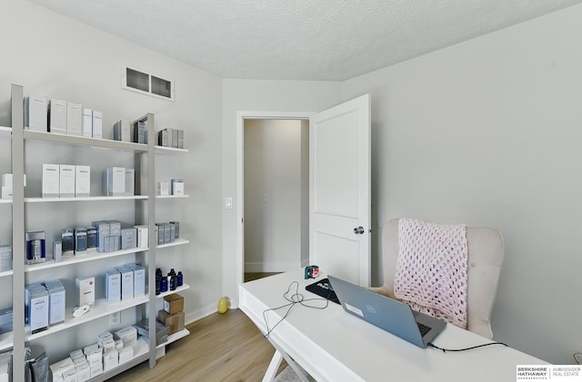 4019 N 147th St, Omaha, NE 68116 - home office with wood finished floors, a textured ceiling, and baseboards