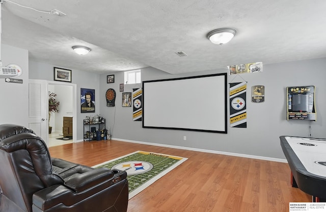 4019 N 147th St, Omaha, NE 68116 - cinema room featuring wood finished floors, baseboards, and a textured ceiling