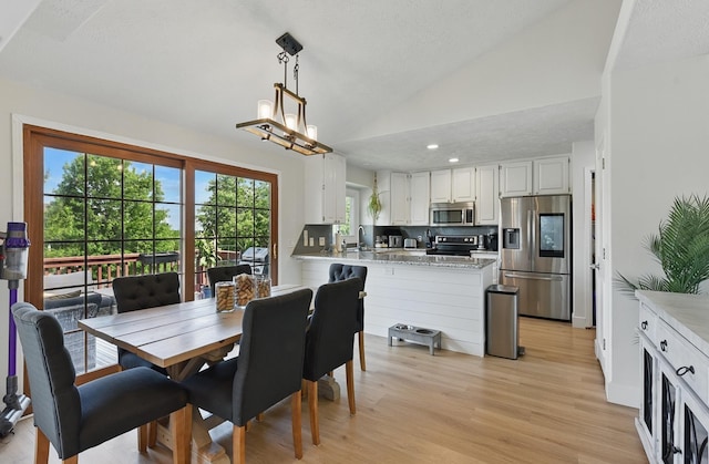 4019 N 147th St, Omaha, NE 68116 - dining room with lofted ceiling, light wood-style floors, recessed lighting, and a textured ceiling