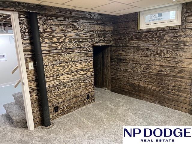1406 S 55th St, Omaha, NE 68106 - finished below grade area with carpet flooring, stairway, and a paneled ceiling