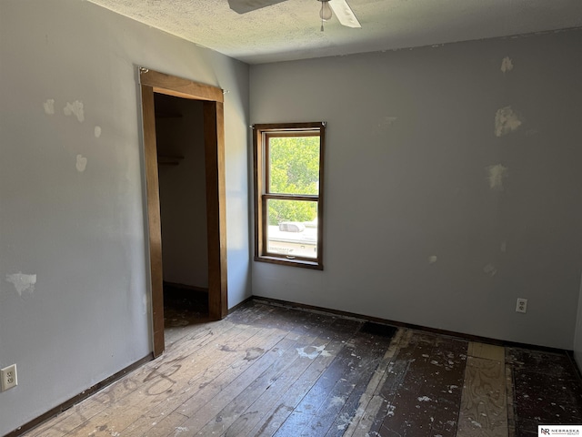 204 E York Ave, Dewitt, NE 68341 - spare room with hardwood / wood-style floors, baseboards, a ceiling fan, and a textured ceiling