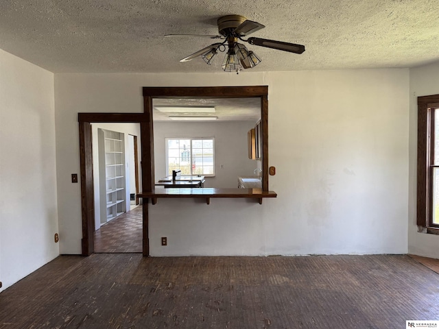 204 E York Ave, Dewitt, NE 68341 - unfurnished living room with wood finished floors, ceiling fan, and a textured ceiling
