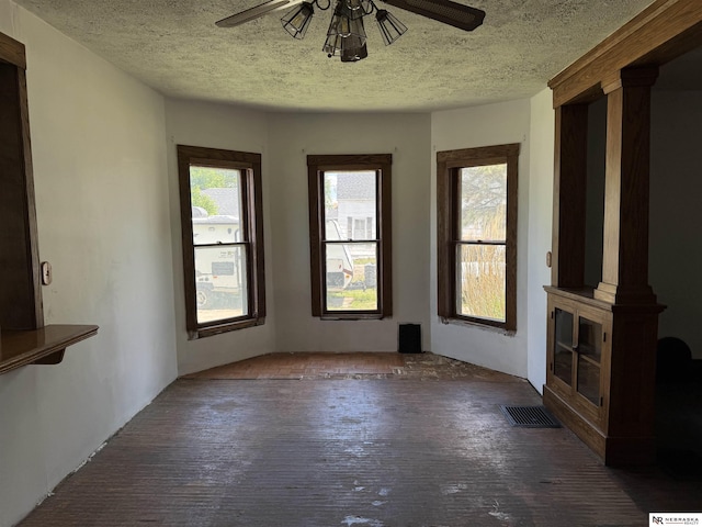 204 E York Ave, Dewitt, NE 68341 - unfurnished living room with a ceiling fan, a textured ceiling, and wood finished floors