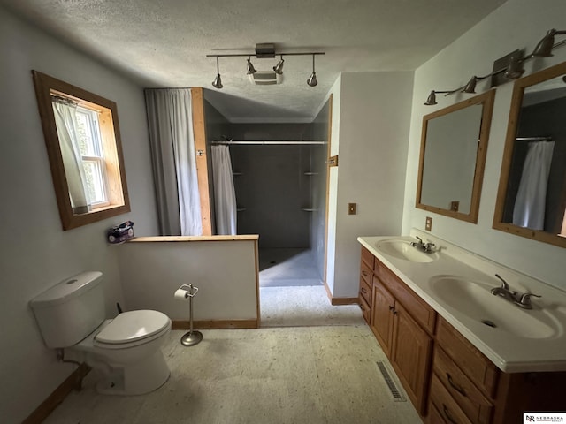 204 E York Ave, Dewitt, NE 68341 - bathroom with double vanity, curtained shower, baseboards, toilet, and a textured ceiling