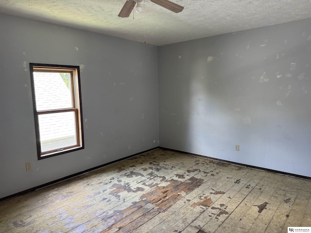 204 E York Ave, Dewitt, NE 68341 - empty room featuring hardwood / wood-style flooring, a textured ceiling, ceiling fan, and baseboards