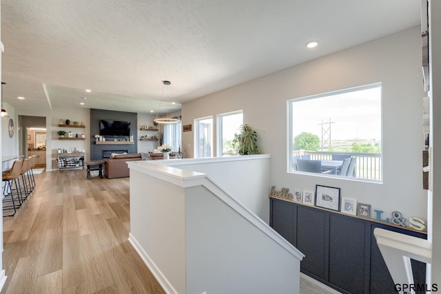 18403 Greenleaf St, Omaha, NE 68136 - hallway with light wood-style floors, recessed lighting, an upstairs landing, and a textured ceiling