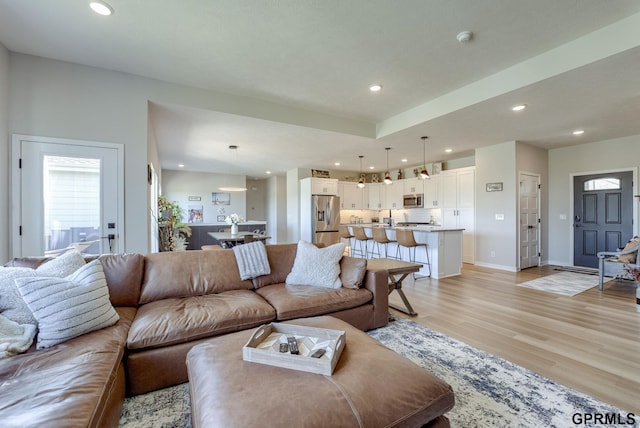 18403 Greenleaf St, Omaha, NE 68136 - living room featuring light wood-style flooring, recessed lighting, plenty of natural light, and baseboards