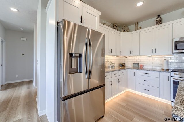 18403 Greenleaf St, Omaha, NE 68136 - kitchen featuring stainless steel appliances, light wood-style flooring, backsplash, white cabinetry, and recessed lighting