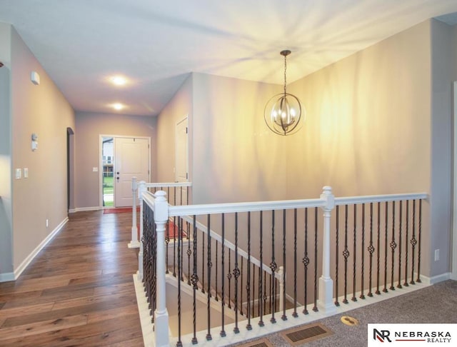 10425 S 110th St, Papillion, NE 68046 - hall with an upstairs landing, wood finished floors, a chandelier, and baseboards