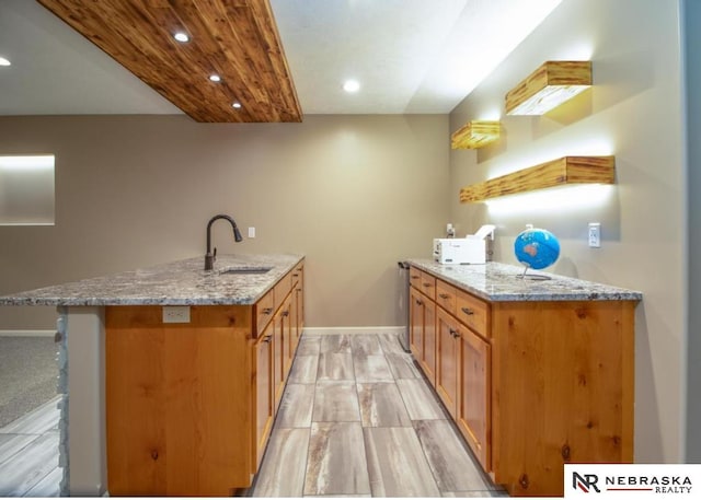 10425 S 110th St, Papillion, NE 68046 - kitchen featuring a sink, a peninsula, recessed lighting, baseboards, and light stone countertops