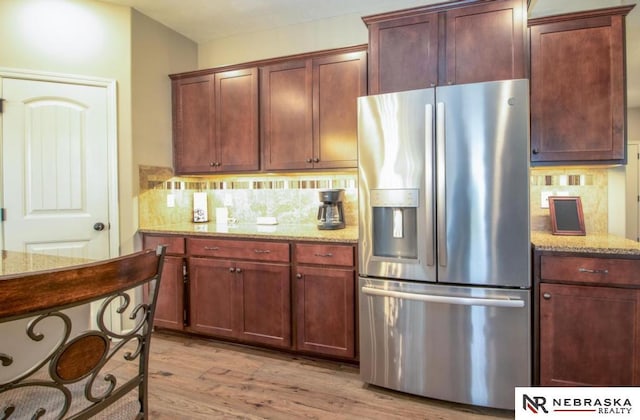 10425 S 110th St, Papillion, NE 68046 - kitchen featuring stainless steel refrigerator with ice dispenser, tasteful backsplash, light wood-type flooring, and light stone counters