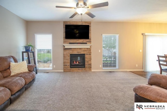 10425 S 110th St, Papillion, NE 68046 - living room featuring ceiling fan, a large fireplace, baseboards, and carpet