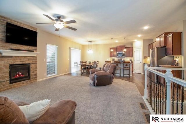 10425 S 110th St, Papillion, NE 68046 - living area with a ceiling fan, a fireplace, dark wood-type flooring, recessed lighting, and baseboards