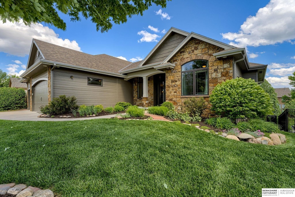 15109 Gilder Ave, Bennington, NE 68007 - view of front facade with stone siding, a front lawn, an attached garage, and roof with shingles