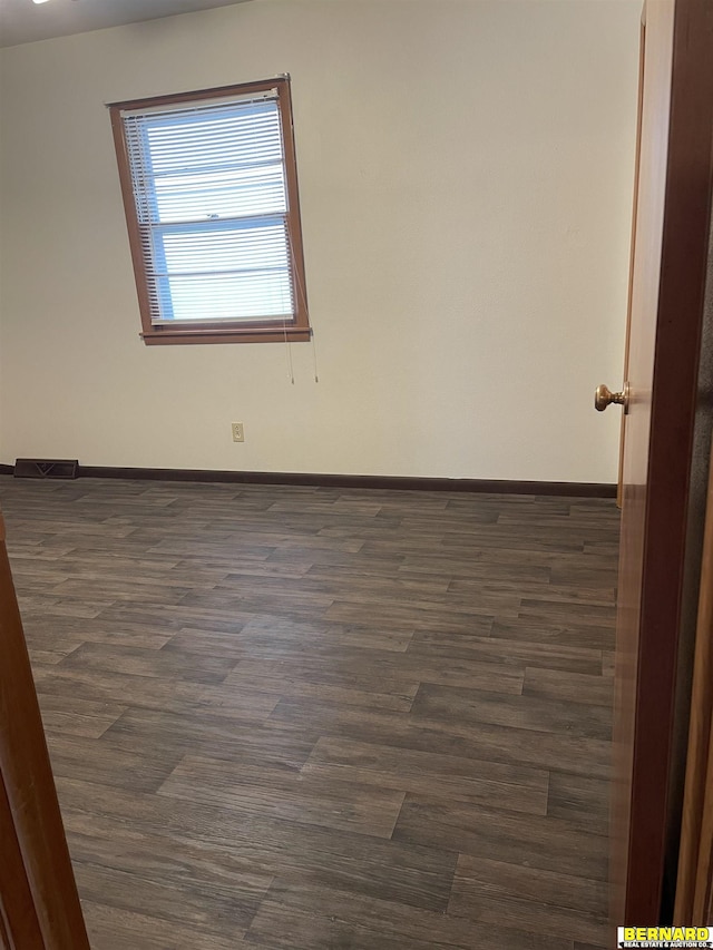 608 N 16th St, Nebraska City, NE 68410 - spare room featuring baseboards and dark wood finished floors