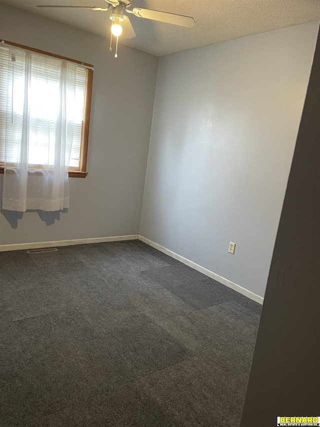 608 N 16th St, Nebraska City, NE 68410 - empty room with a ceiling fan, dark colored carpet, and baseboards