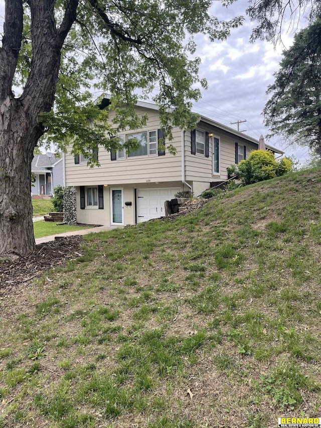 608 N 16th St, Nebraska City, NE 68410 - view of front of house featuring a garage and a front lawn