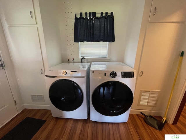 5427 W Hughes St, Lincoln, NE 68524 - laundry room with separate washer and dryer, wood finished floors, and baseboards