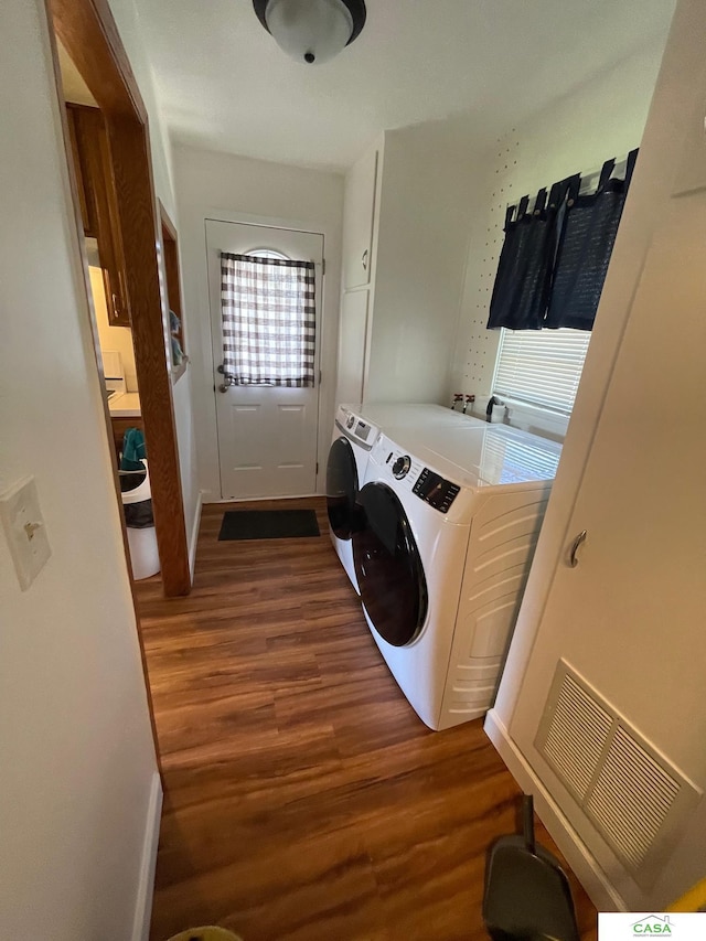 5427 W Hughes St, Lincoln, NE 68524 - laundry room with dark wood-style flooring, independent washer and dryer, and baseboards