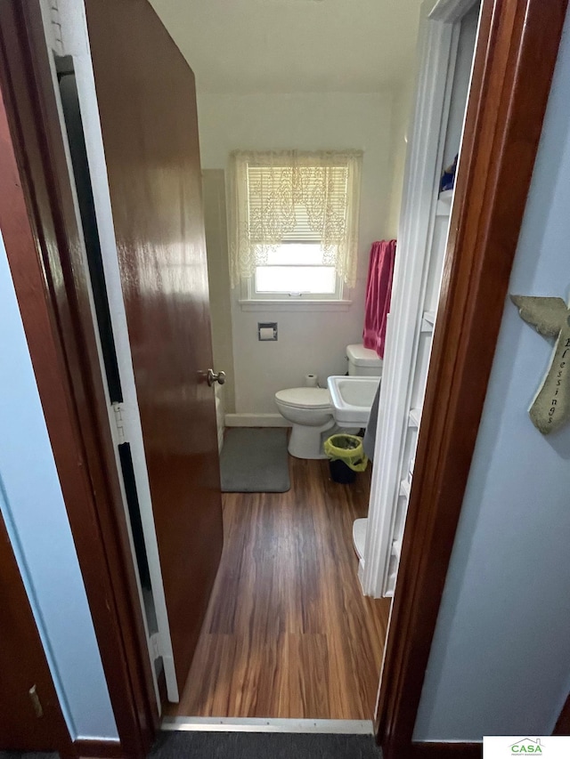 5427 W Hughes St, Lincoln, NE 68524 - half bath with toilet, wood finished floors, baseboards, and a sink