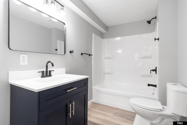 1204 S 27th St, Omaha, NE 68105 - bathroom featuring toilet, vanity, wood finished floors, and tub / shower combination