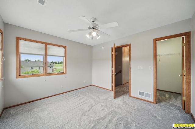 5665 I Rd, Nebraska City, NE 68410 - unfurnished bedroom with carpet floors, baseboards, a spacious closet, ceiling fan, and a closet