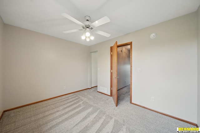 5665 I Rd, Nebraska City, NE 68410 - unfurnished bedroom featuring light carpet, baseboards, and a ceiling fan