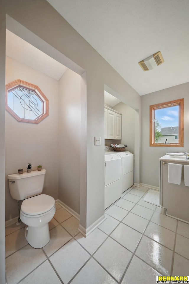 5665 I Rd, Nebraska City, NE 68410 - half bathroom with washer and dryer, vanity, toilet, tile patterned flooring, and baseboards