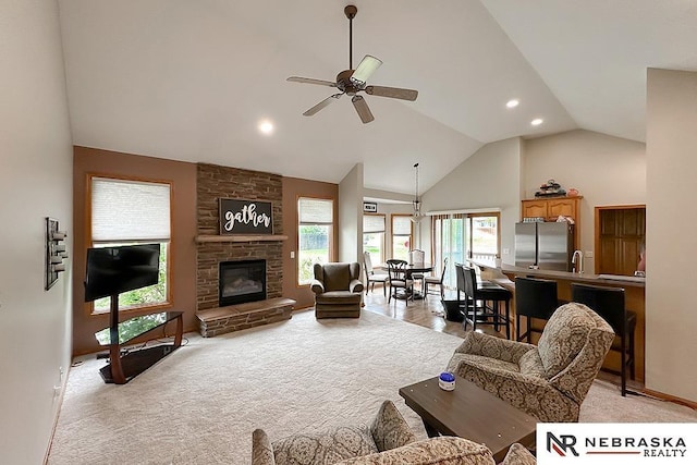 21204 Hampton Dr, Gretna, NE 68028 - living room featuring ceiling fan, recessed lighting, high vaulted ceiling, light colored carpet, and a fireplace
