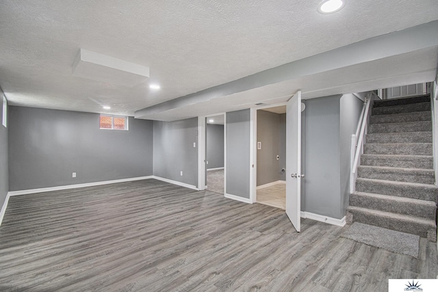3810 Corby St, Omaha, NE 68111 - basement with a textured ceiling, wood finished floors, stairs, baseboards, and recessed lighting