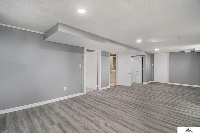 3810 Corby St, Omaha, NE 68111 - finished basement with wood finished floors, baseboards, a textured ceiling, and recessed lighting