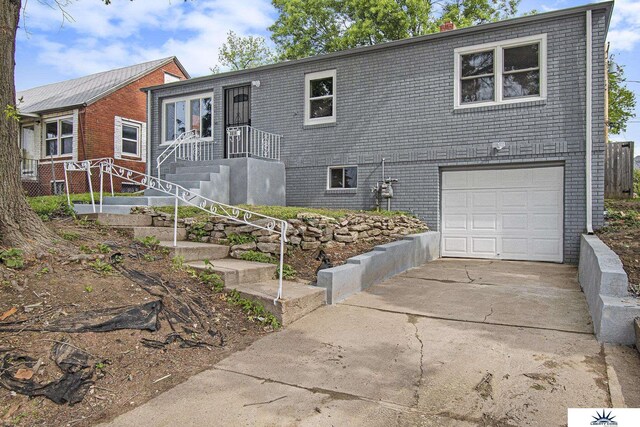 3810 Corby St, Omaha, NE 68111 - view of front of house featuring a garage, driveway, and brick siding
