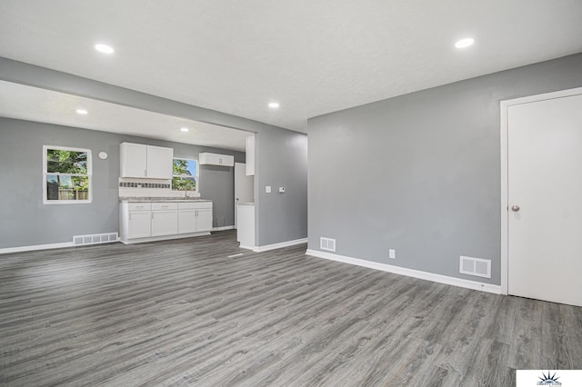 3810 Corby St, Omaha, NE 68111 - unfurnished living room with wood finished floors, baseboards, and recessed lighting