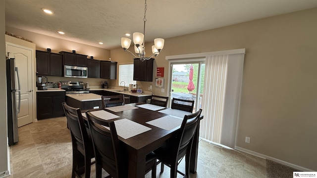7316 N 142nd Ave, Omaha, NE 68142 - dining room with a chandelier, recessed lighting, baseboards, and a textured ceiling