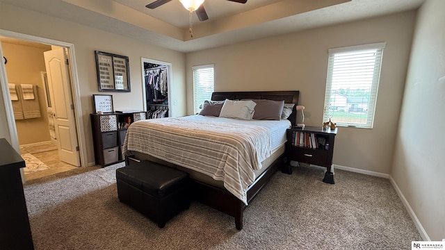 7316 N 142nd Ave, Omaha, NE 68142 - bedroom featuring carpet floors, baseboards, connected bathroom, and a walk in closet