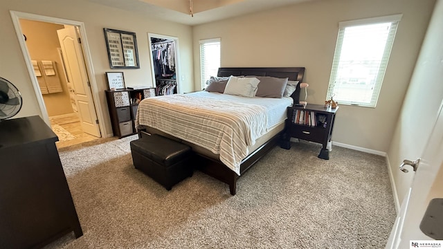 7316 N 142nd Ave, Omaha, NE 68142 - carpeted bedroom featuring a walk in closet, ensuite bathroom, a closet, and baseboards