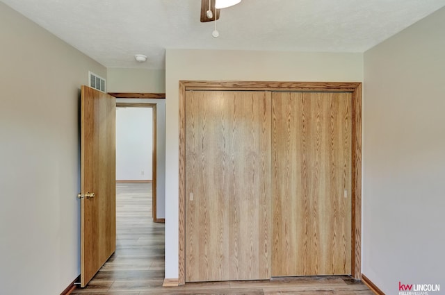 235 W Belmont Ave, Lincoln, NE 68521 - unfurnished bedroom with wood finished floors, ceiling fan, and baseboards