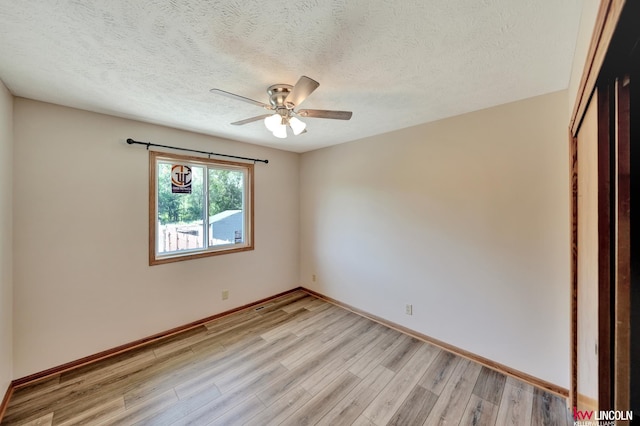 235 W Belmont Ave, Lincoln, NE 68521 - empty room featuring light wood-type flooring, ceiling fan, baseboards, and a textured ceiling