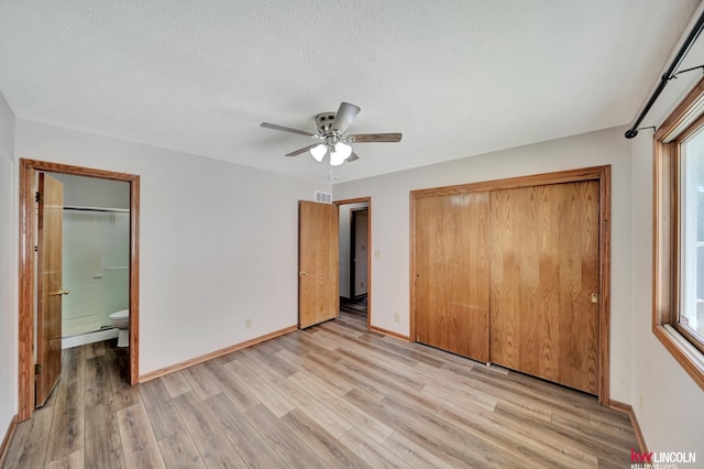 235 W Belmont Ave, Lincoln, NE 68521 - unfurnished bedroom featuring light wood finished floors, baseboards, a closet, ensuite bathroom, and ceiling fan