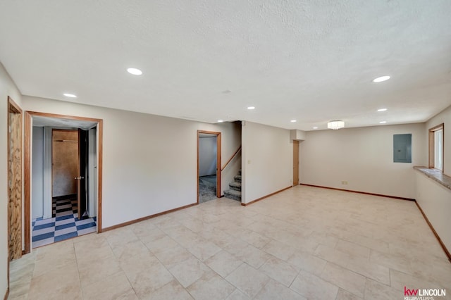 235 W Belmont Ave, Lincoln, NE 68521 - finished basement featuring stairs, electric panel, recessed lighting, baseboards, and a textured ceiling