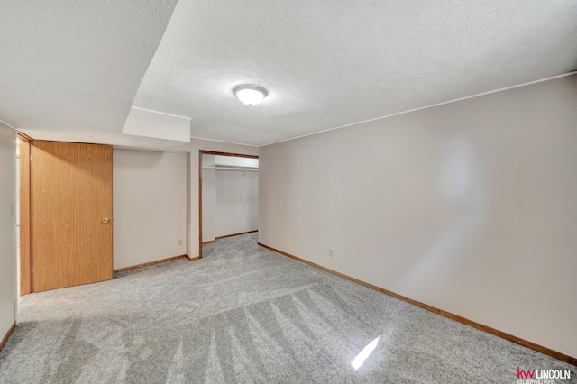 235 W Belmont Ave, Lincoln, NE 68521 - unfurnished bedroom with light colored carpet, baseboards, and a textured ceiling