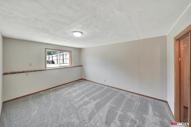 235 W Belmont Ave, Lincoln, NE 68521 - carpeted spare room with baseboards and a textured ceiling