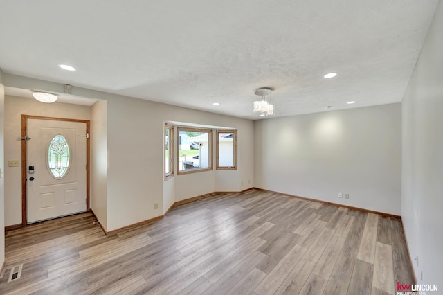 235 W Belmont Ave, Lincoln, NE 68521 - entryway featuring plenty of natural light, recessed lighting, baseboards, a chandelier, and light wood-type flooring