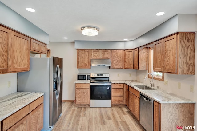 235 W Belmont Ave, Lincoln, NE 68521 - kitchen with appliances with stainless steel finishes, range hood, a sink, light wood-style floors, and light stone counters