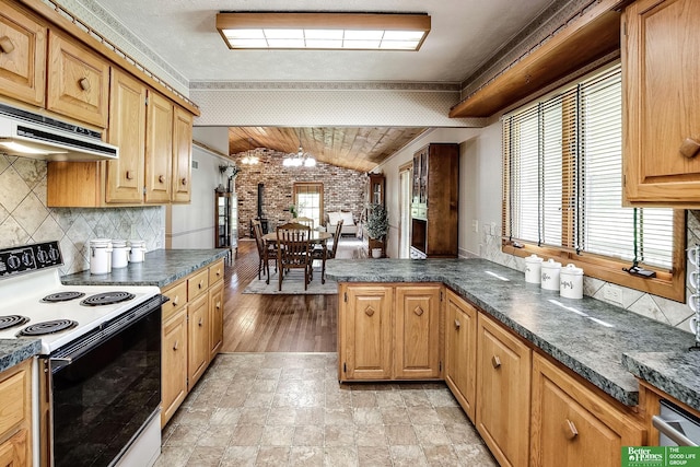 9706 N 51st St, Omaha, NE 68152 - kitchen with range with electric stovetop, vaulted ceiling, dark countertops, backsplash, and brick wall