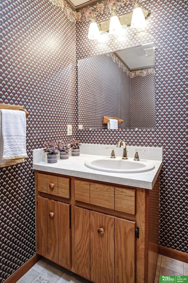 9706 N 51st St, Omaha, NE 68152 - bathroom with vanity, baseboards, tile patterned flooring, and wallpapered walls