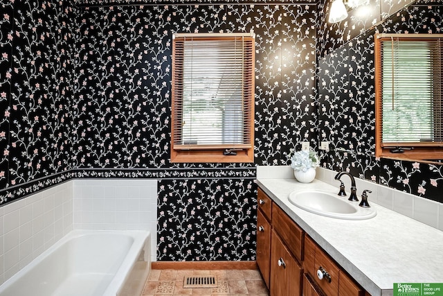 9706 N 51st St, Omaha, NE 68152 - bathroom with wallpapered walls, vanity, a tub, and tile patterned flooring